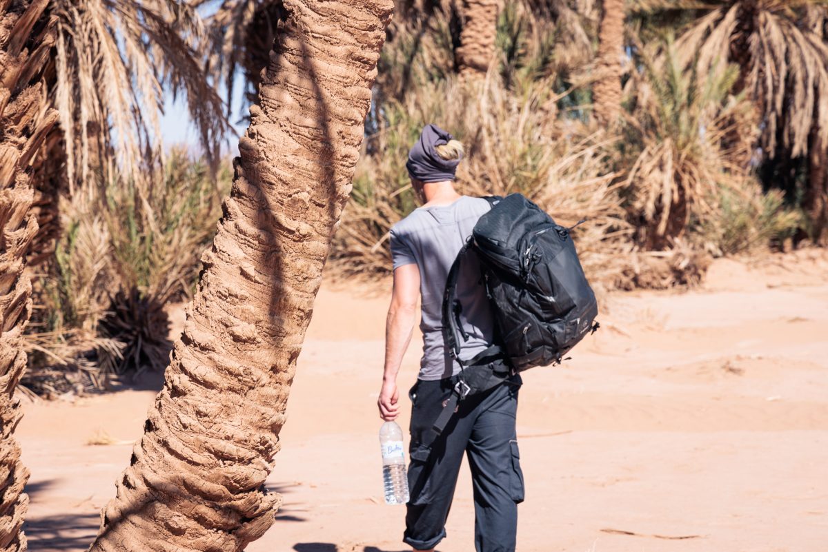 f-stop Tilopa 50 liter DuraDiamond® camera backpack in the Anthracite Black color option on a beach