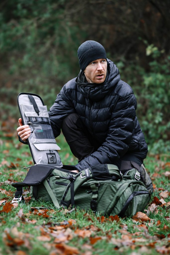 Portrait of Jesper Gronnemark with the Tilopa 50L DuraDiamond® Cypress opening bag panel of camera pack 