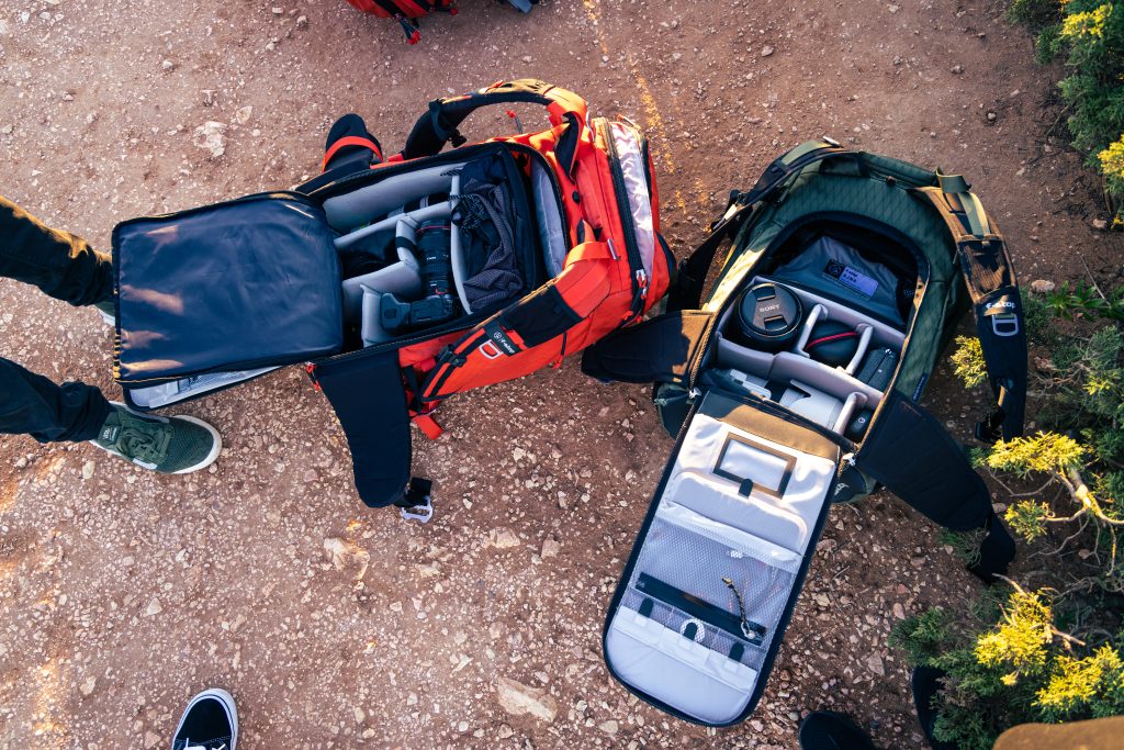 Tilopa with the Large Pro Camera Insert next to the Ajna with the Small Pro on the ground packed with camera gear