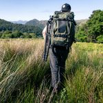 f-stop Ambassador James Fortune pictured with the f-stop Tilopa 50 liter DuraDiamond® camera backpack in the Cypress Green color option with a tripod attached using the f-stop Gatekeeper Straps