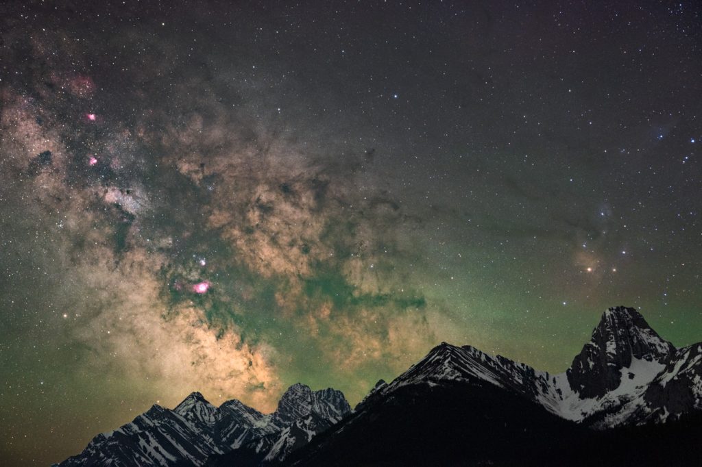 The Galactic Center portion of the Milky Way and Rho Ophiuchi over a mountain range captured by f-stop Ambassador and Astrophotography specialist Monika Deviat
